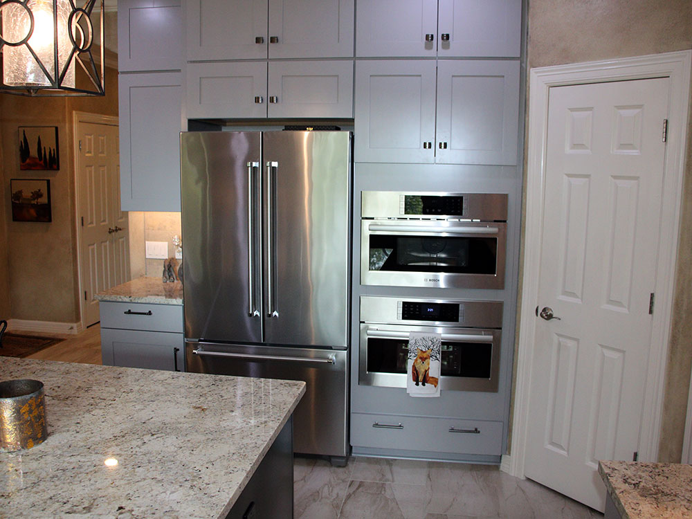 Kitchen fridge and cabinets after remodel