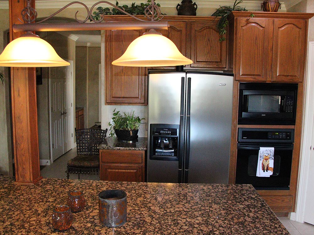 kitchen fridge and cabinets before remodel